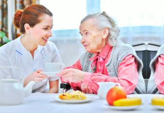 caregiver assisting senior woman